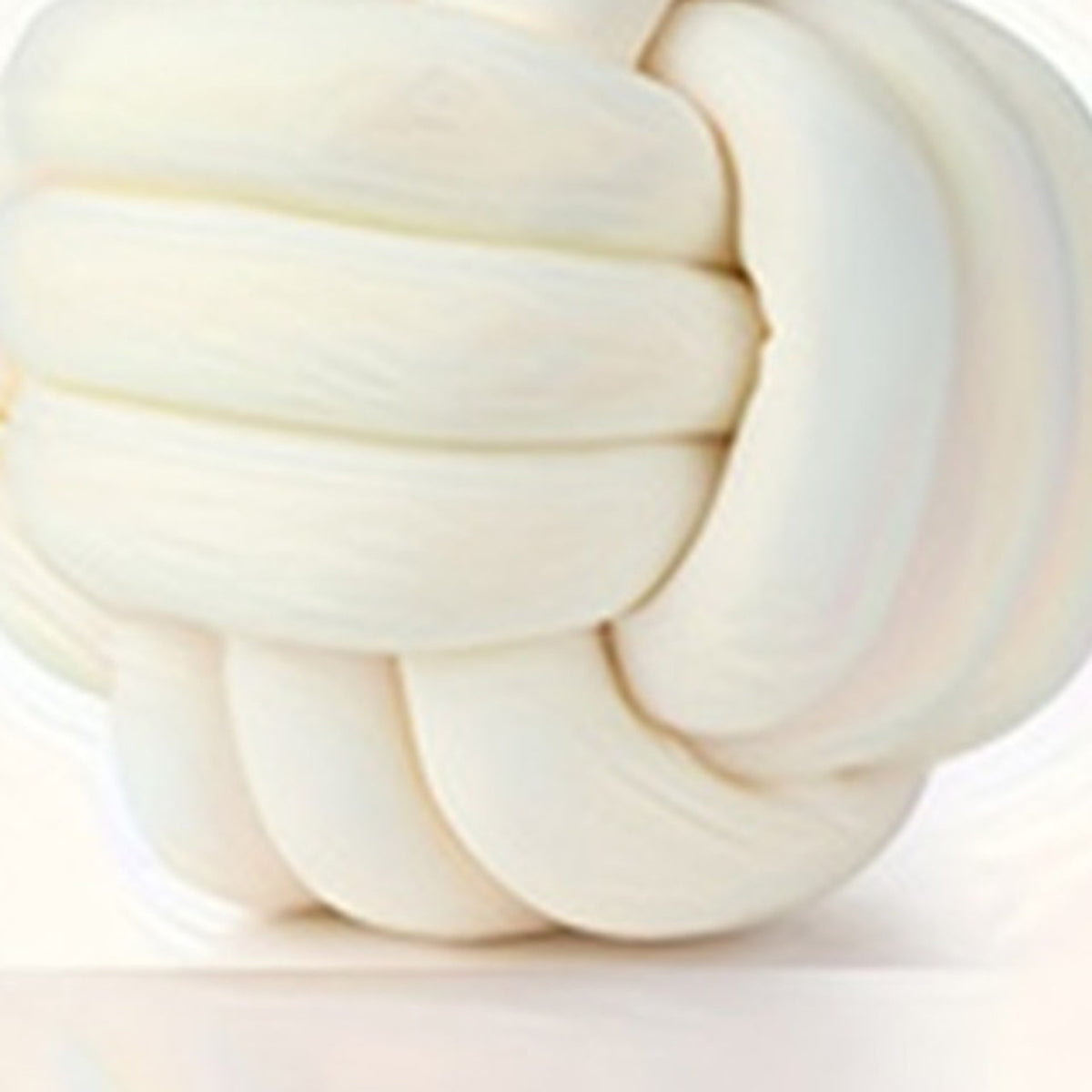 Détail du nœud en velours du coussin crème
